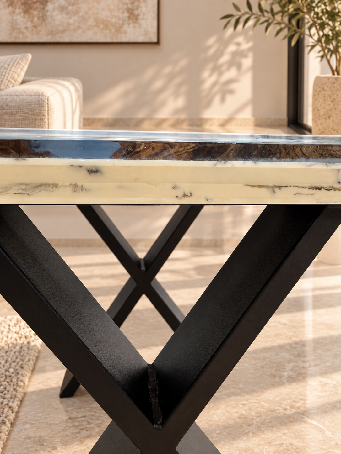 The olive wood side table shown in a bright living space.