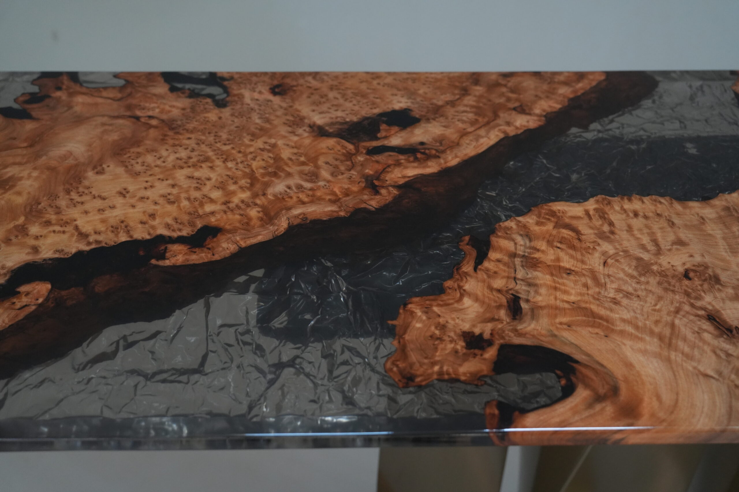 Close-up detail of the grain in the fir burl wood of the Midnight Ice Console.