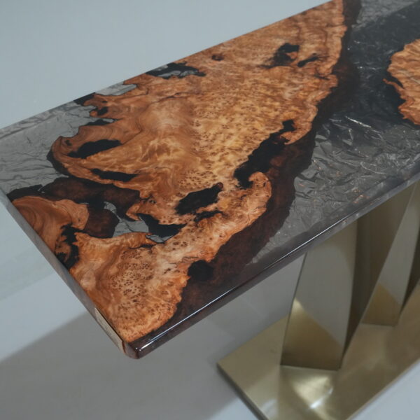 A close-up view of the Midnight Ice Console, showcasing its fir burl top and semi-translucent black epoxy finish.