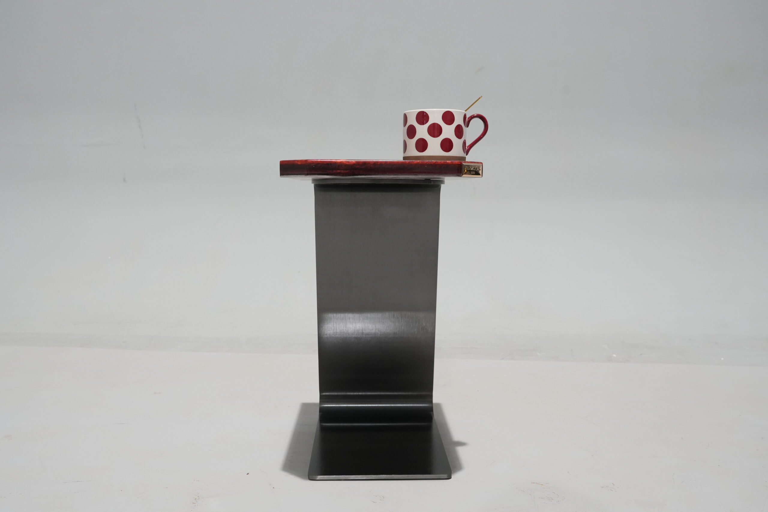 A close-up of the top edge of the Crimson Olive Root Side Table showcasing the beveled edges and resin detail.