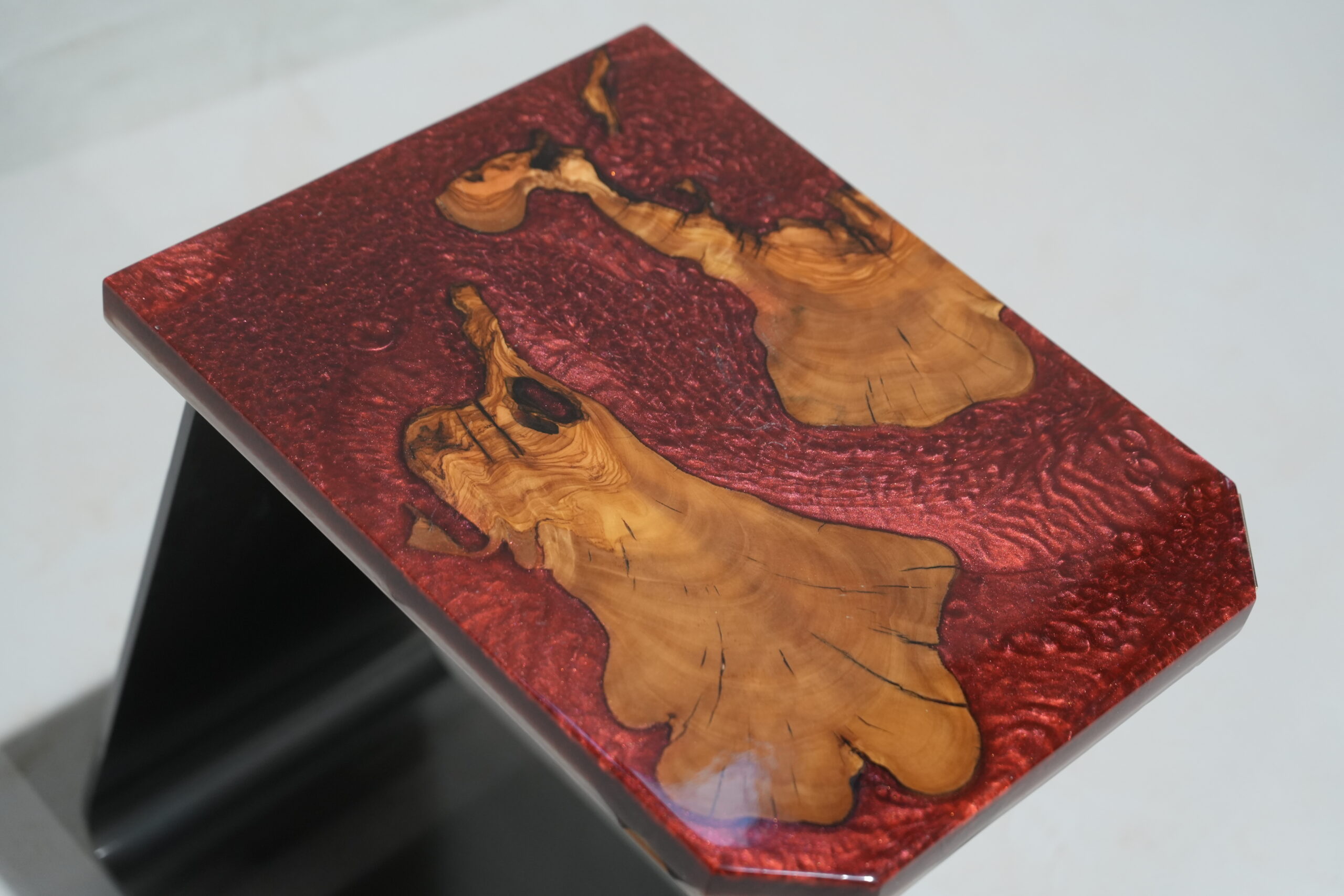 A front view of the Crimson Olive Root Side Table showcasing its entire structure.