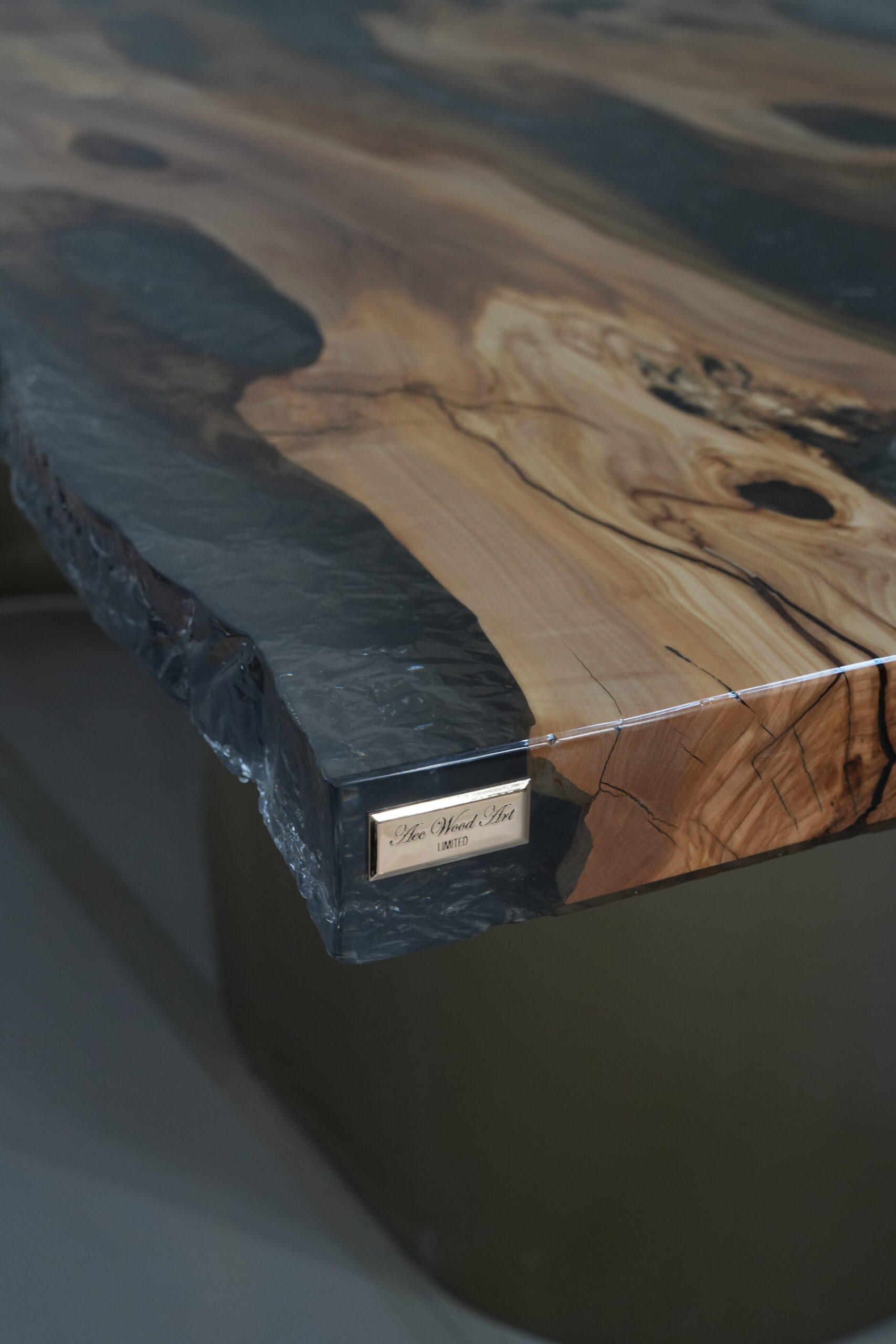 Image of the table's leg showing the brushed champagne gold finish.