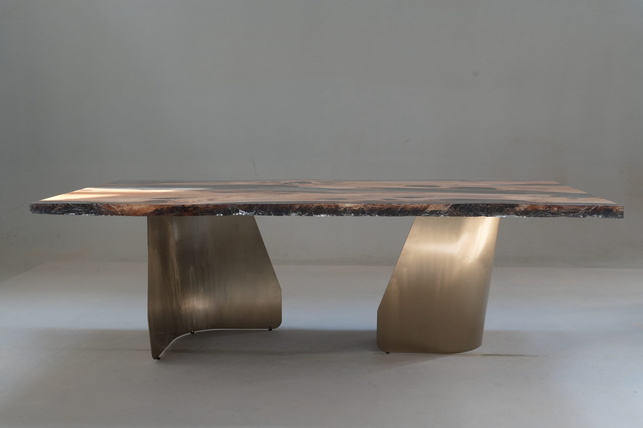 Side view of the Crystal Black Olive Dining Table highlighting the architectural leg.
