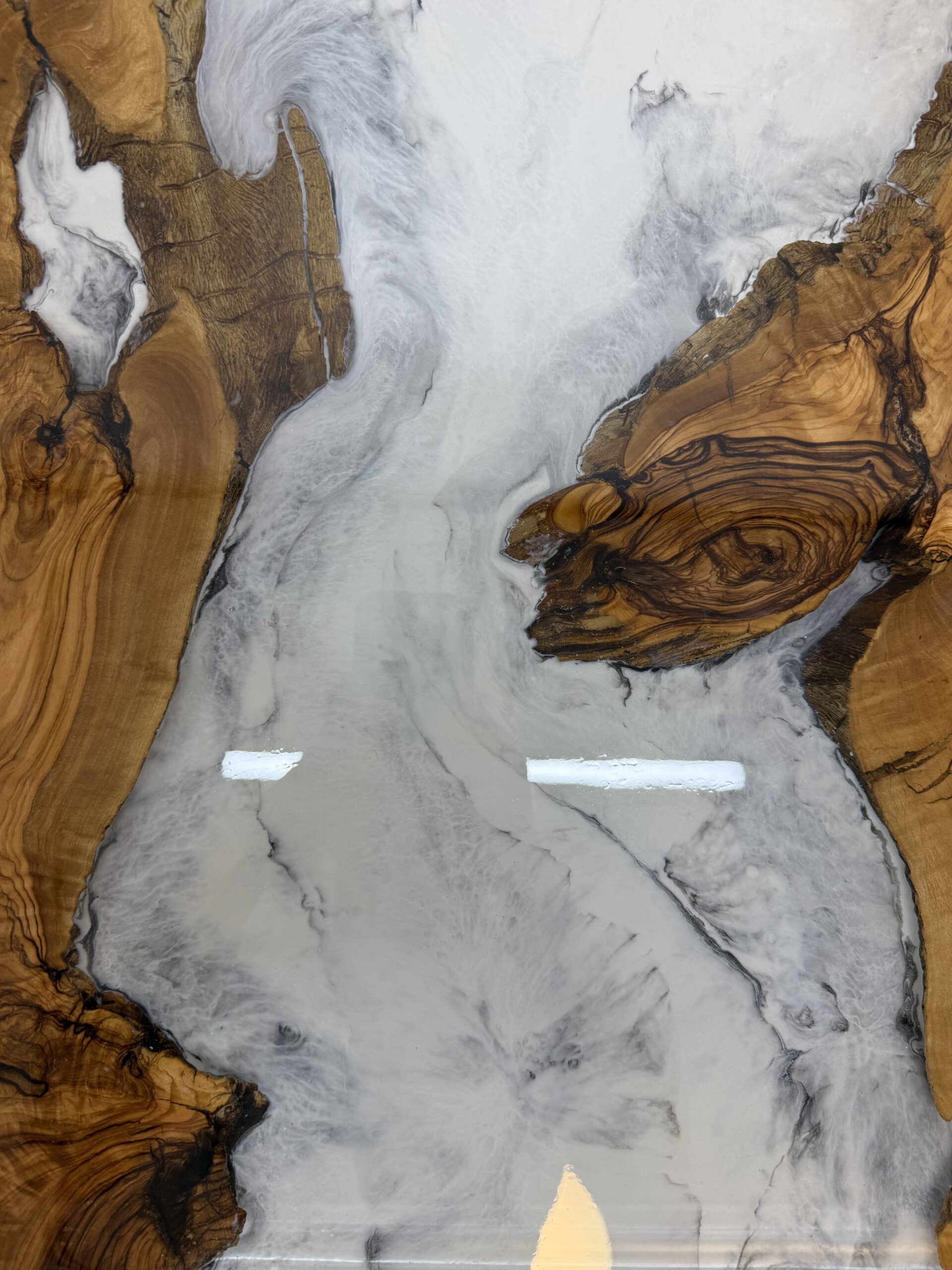 Detailed view of the table showcasing the olive wood and resin.