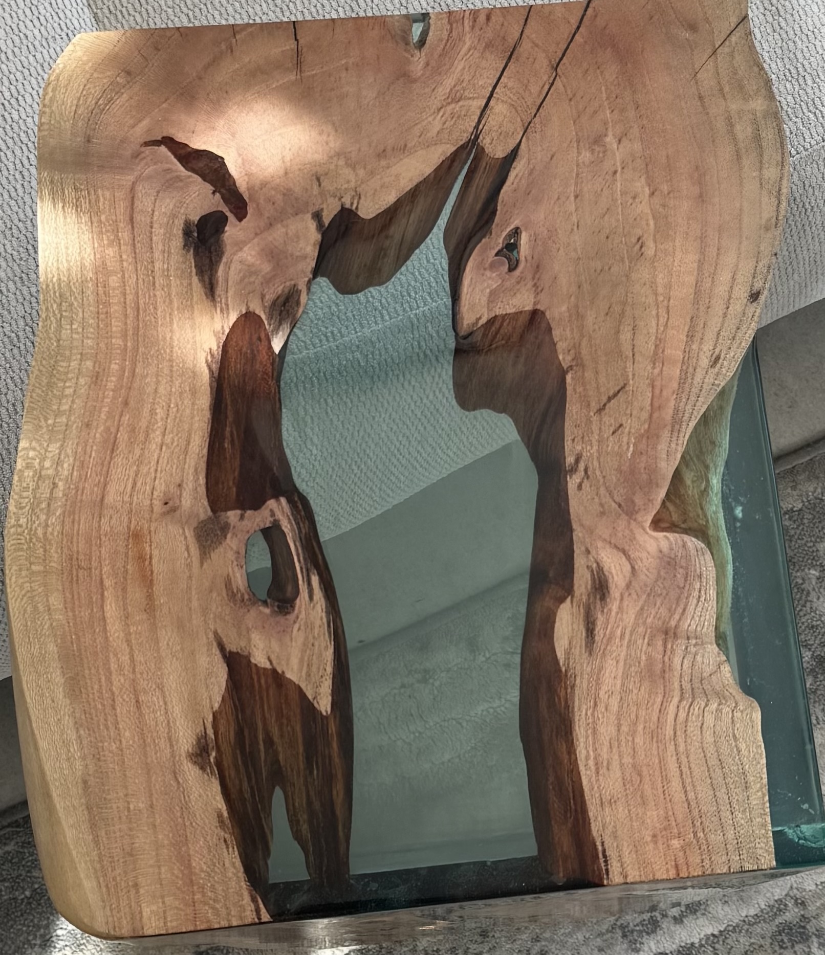 Another top view of the carob wood side table, capturing its detail and finish.