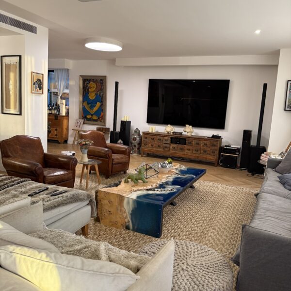 A beautifully styled living room featuring the Oceanic Poplar Epoxy Coffee Table in focus, showcasing its sea-textured epoxy finish and poplar wood.